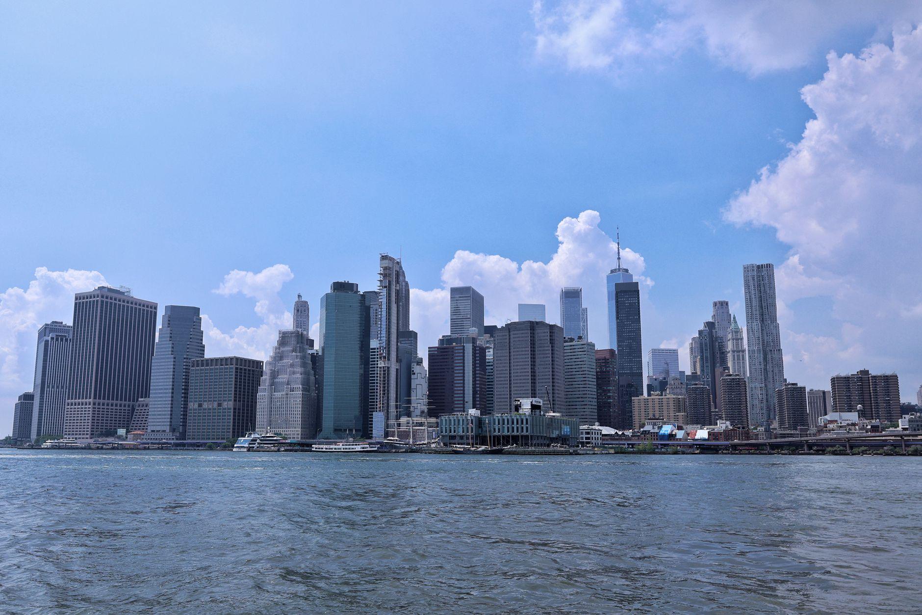 Beautiful view of Manhattan's skyline with a clear blue sky, showcasing modern architecture.