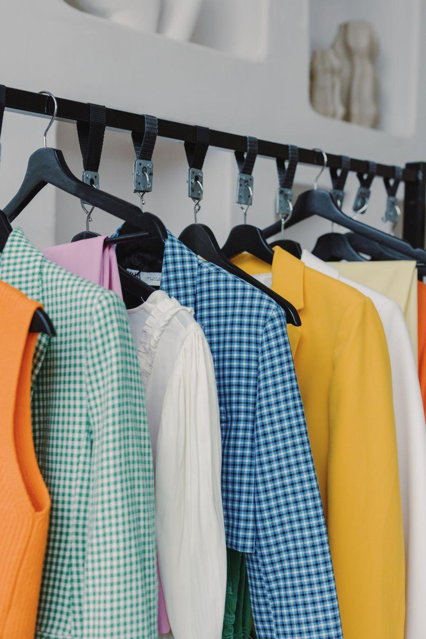 A vibrant display of clothing in a boutique store setting, with various textures and patterns.