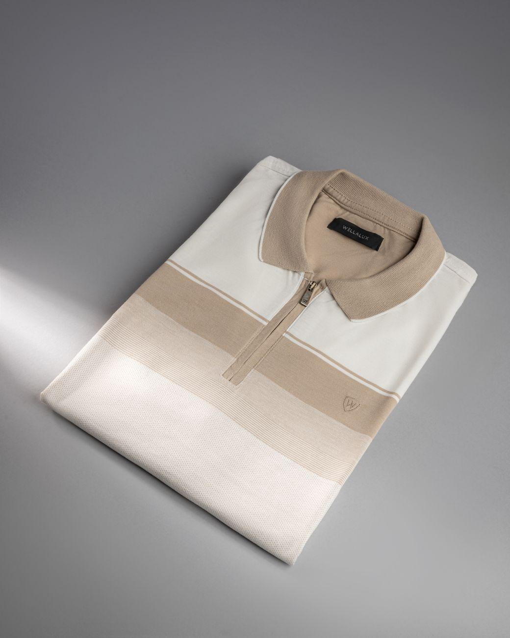 Stylish folded polo shirt in neutral tones on a gray studio background.